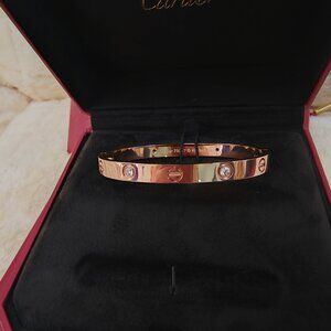 Cartier wide classic four-diamond rose gold bracelet.